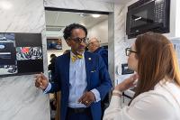 Dentist shows community member features of the mobile health clinic